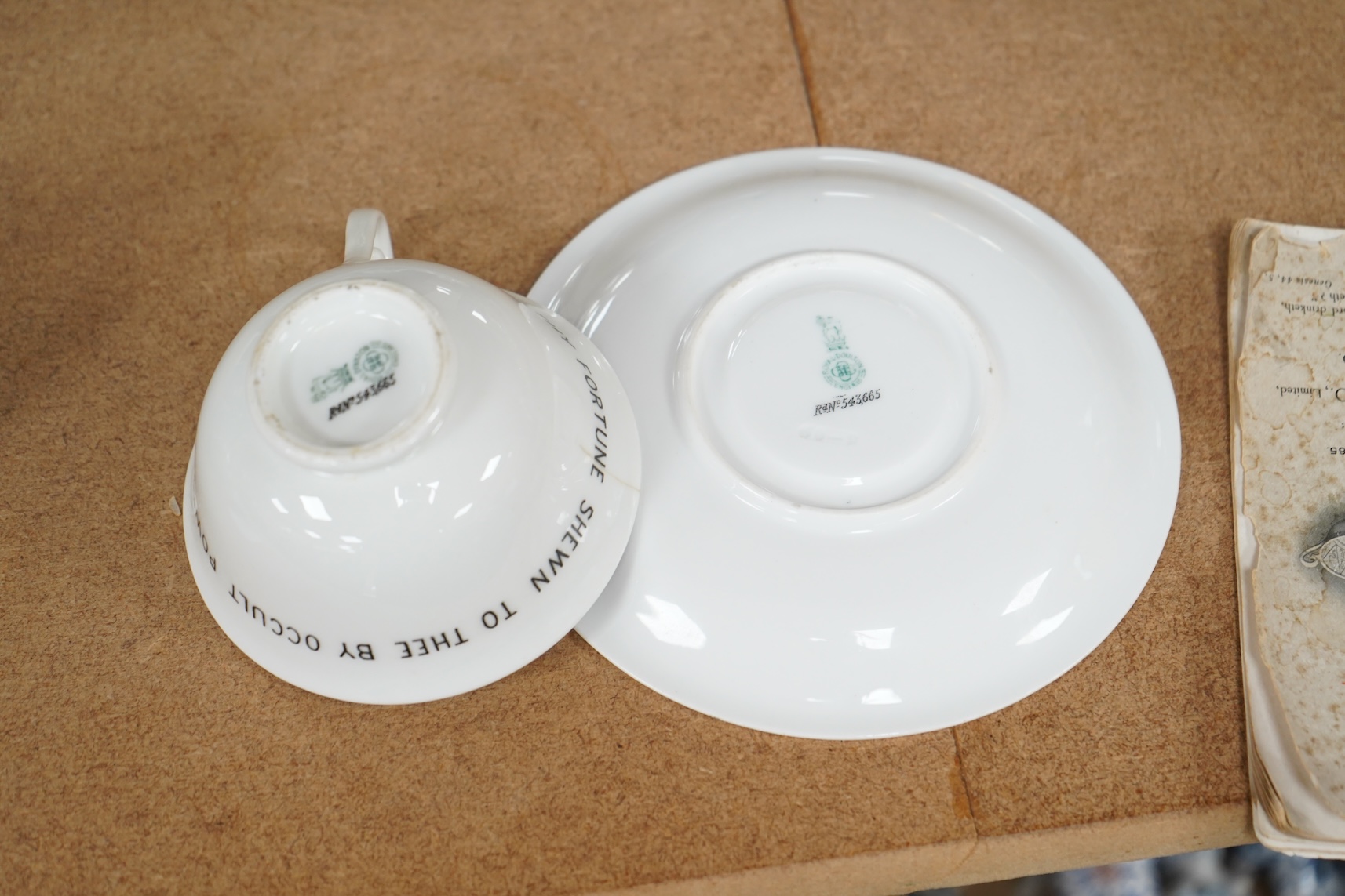 A Royal Doulton 'The Egyptian Divining cup and saucer', with booklet, numbered RN543665